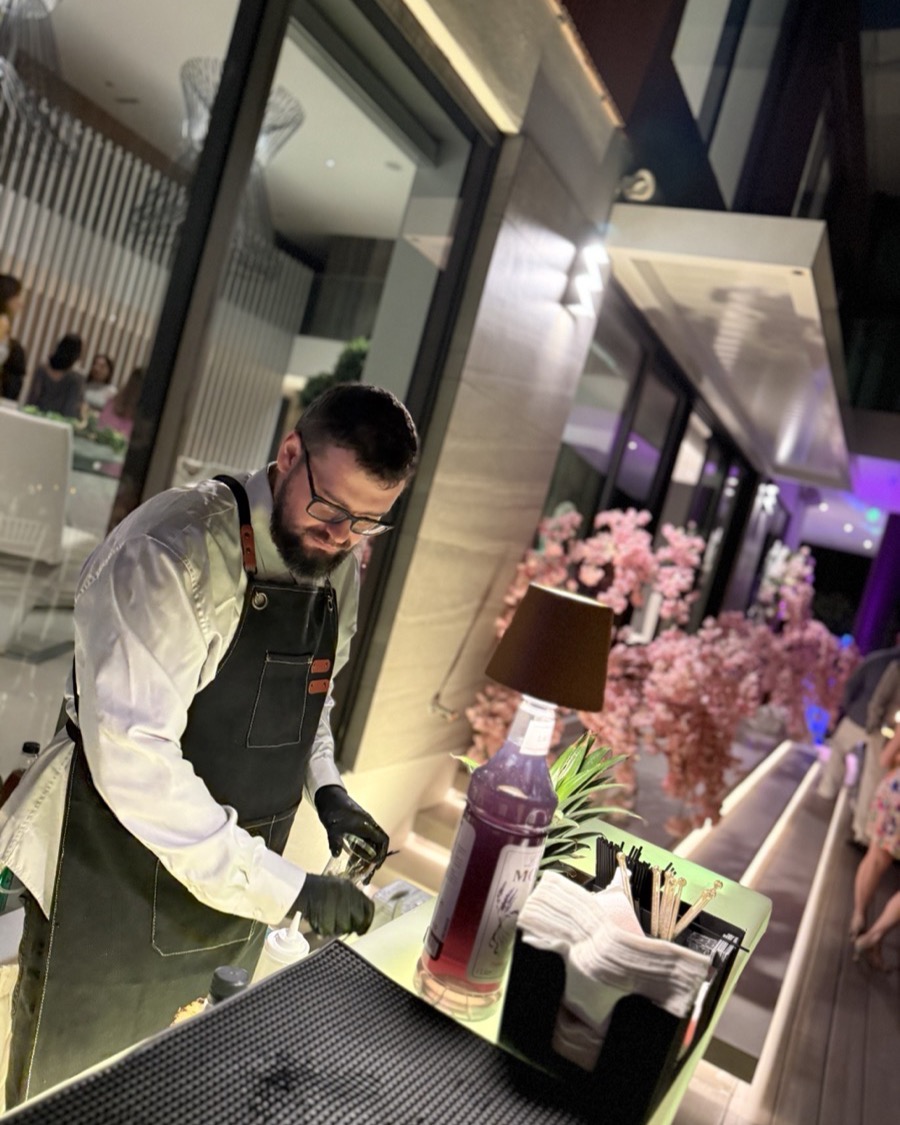 Bartender mixing colorful mocktails at kids party Miami