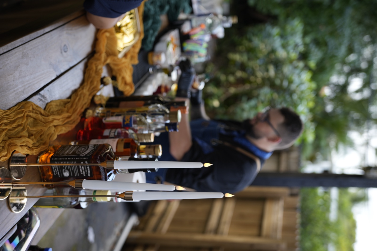 Bartender working at outdoor bar with candles Miami