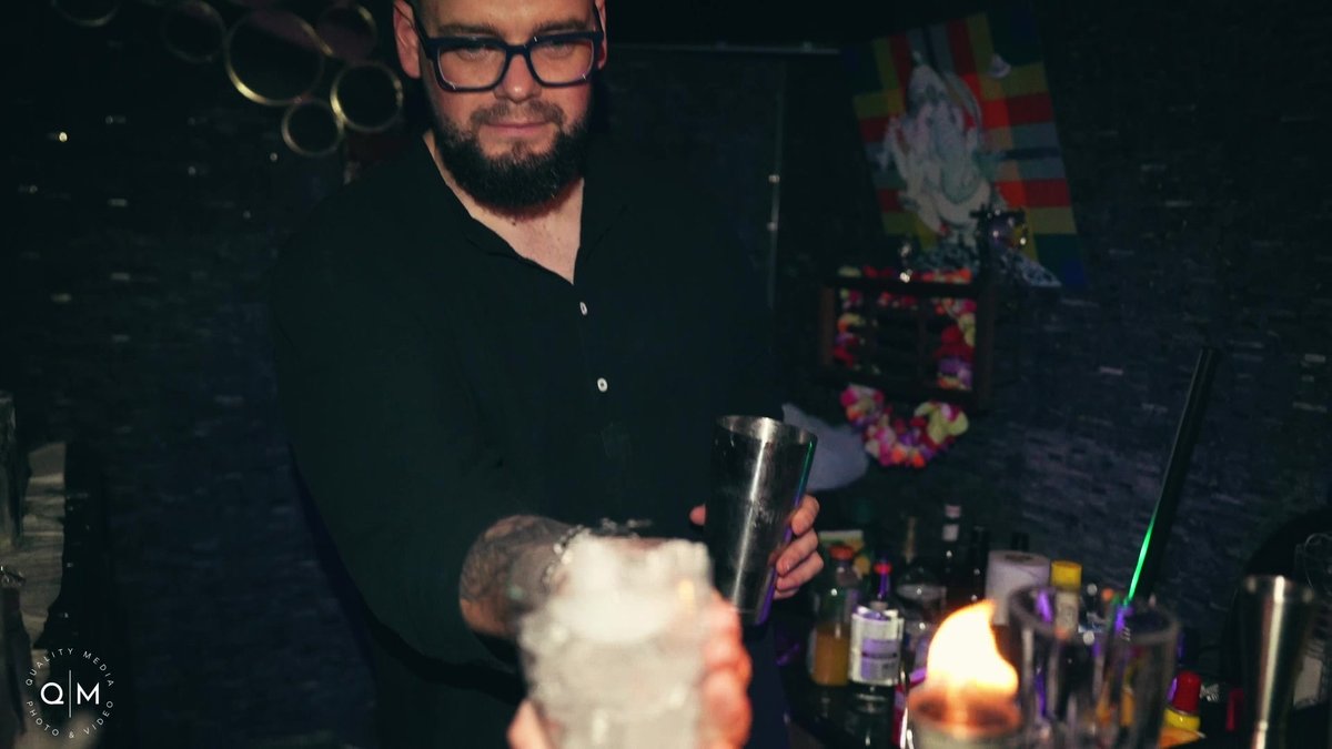 Professional bartender behind bar at Miami birthday event