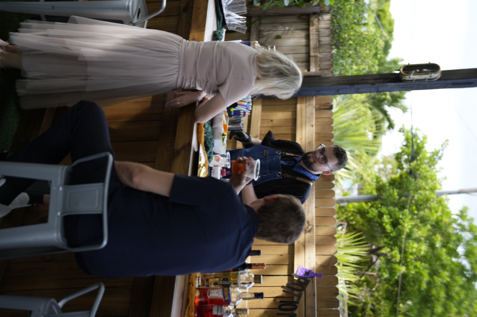 Bartender serving cocktail to guest at outdoor event Miami