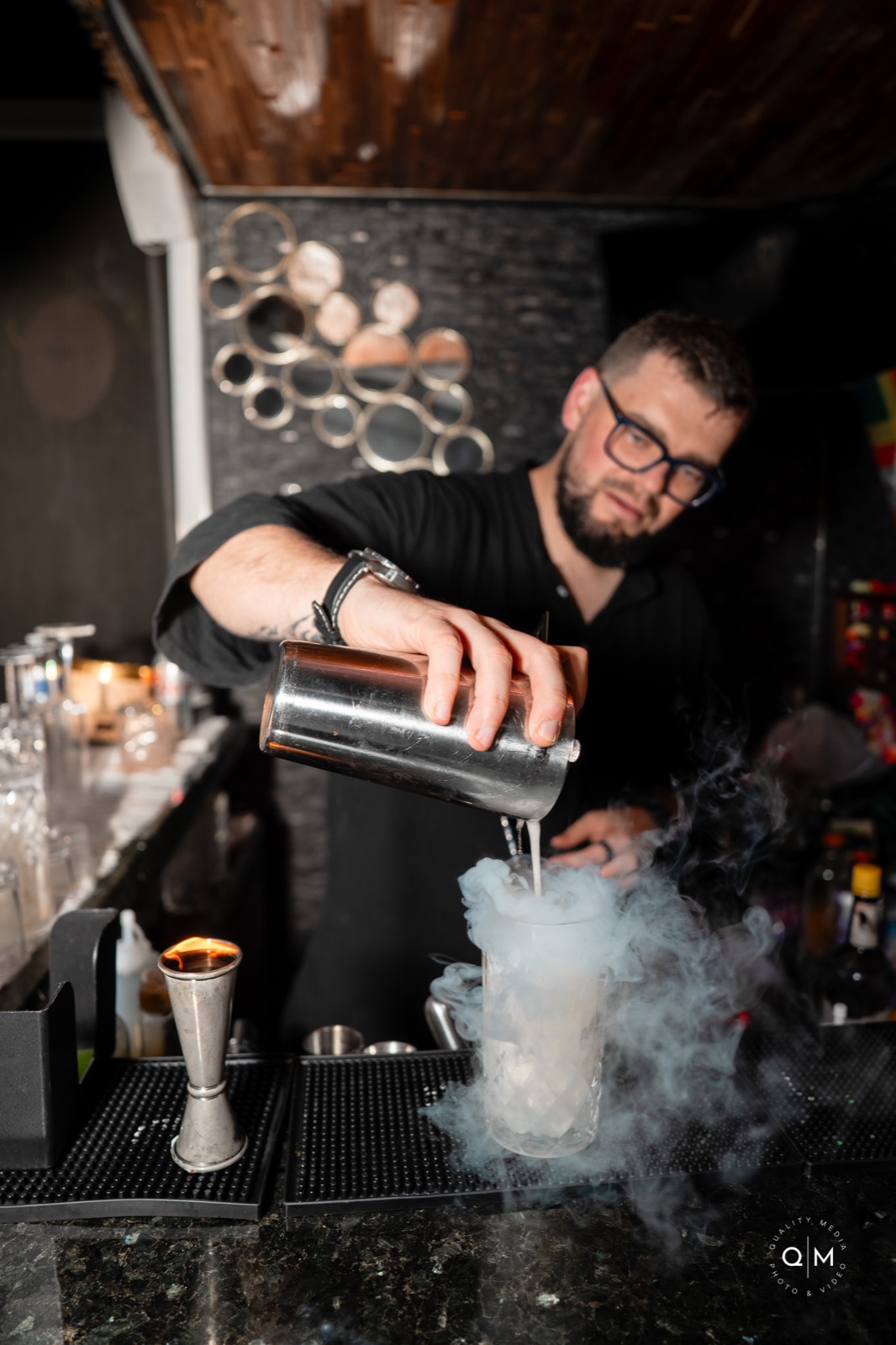 Bartender pouring dry ice smoke cocktail Miami