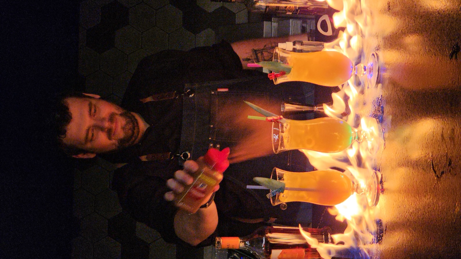 Bartender performing fire show with flaming cocktails Miami
