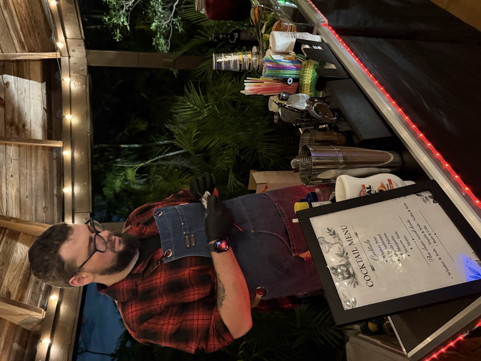 Bartender at portable bar with cocktail menu Miami