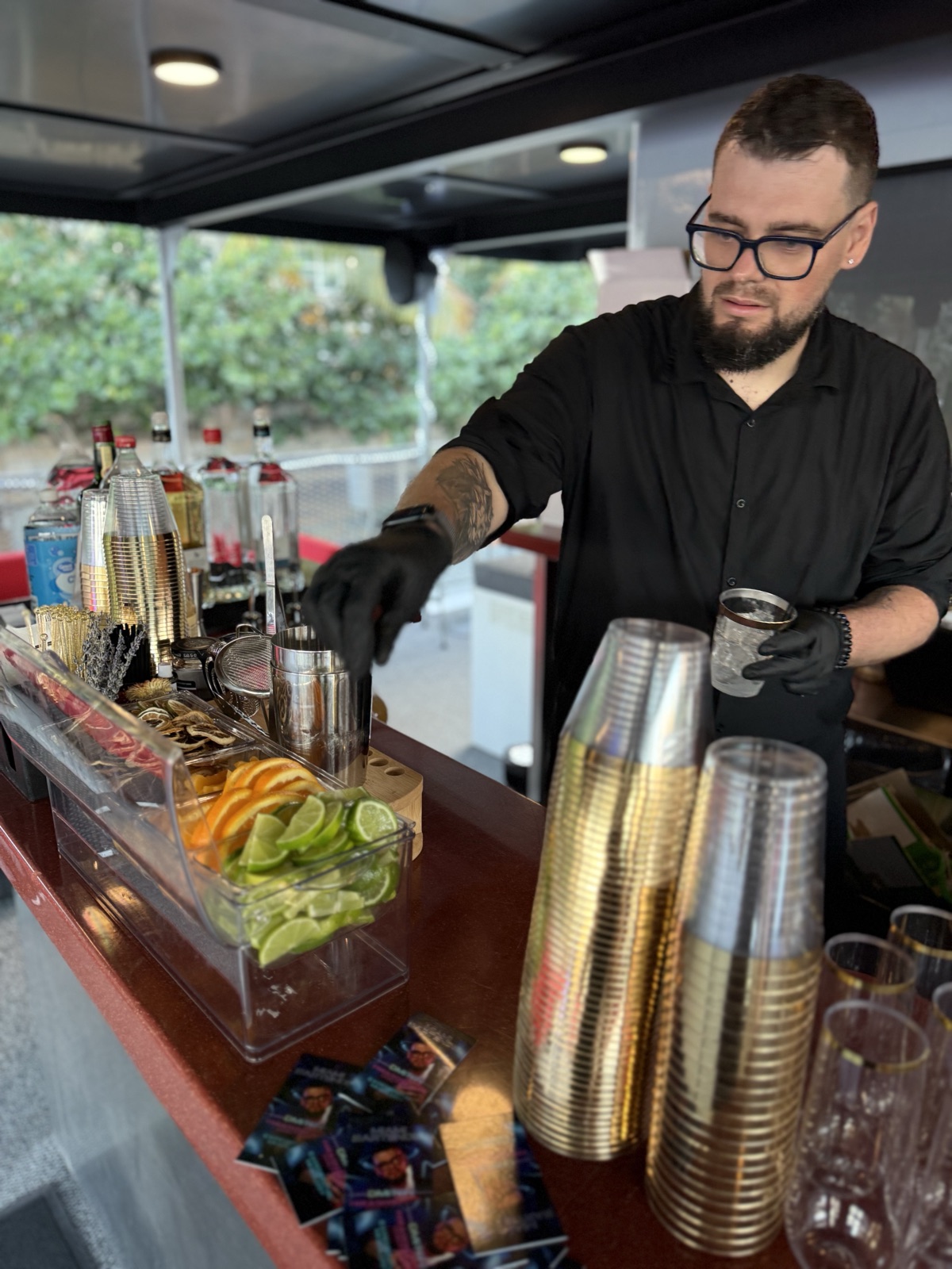 Bartender reaching for cups yacht bar garnishes Miami