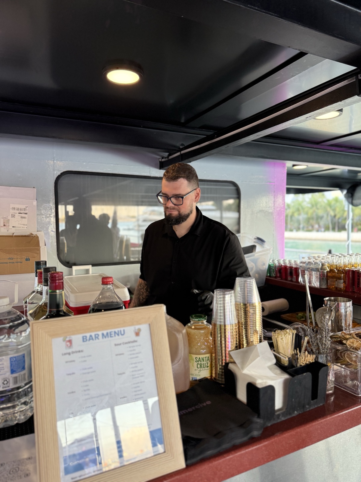 Yacht bartender behind bar with cocktail menu Miami
