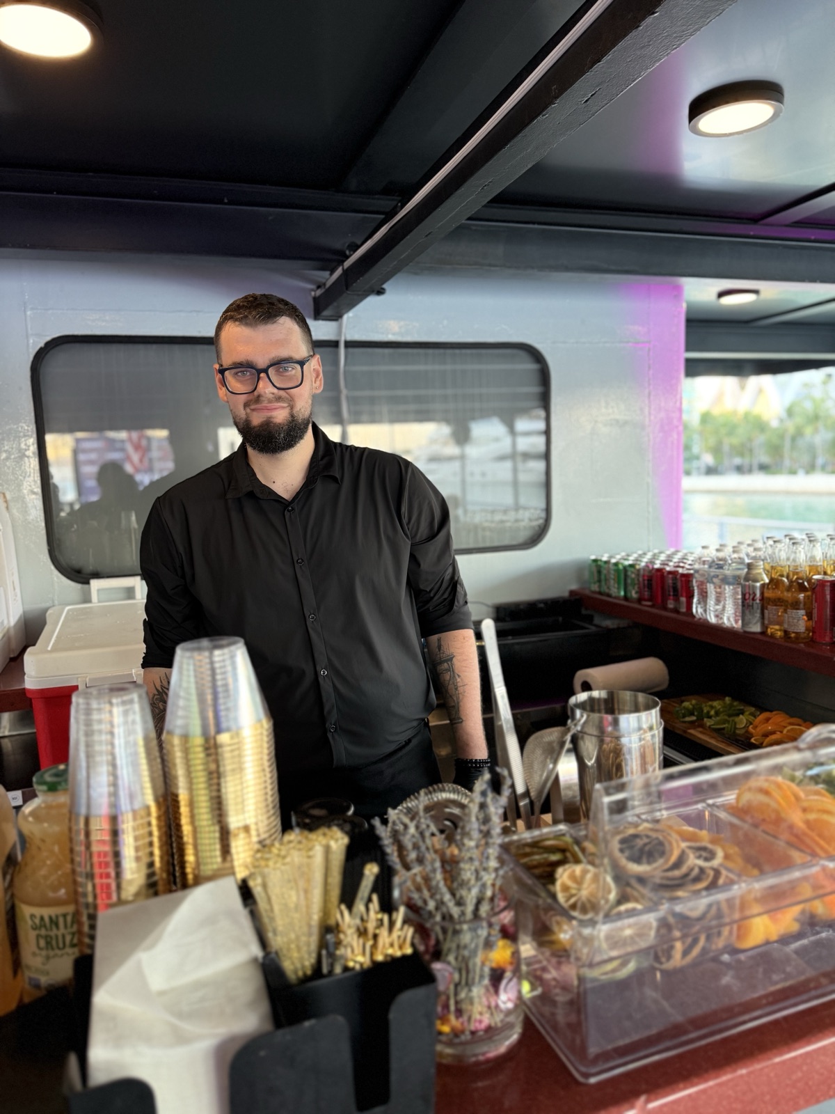 Bartender smiling at yacht bar Miami party